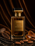 Fèves Gourmandes Kane Parfum — Extrait de Parfum 50 ml, flacon sur marbre noir avec fève tonka, vanille, cacao et caramel